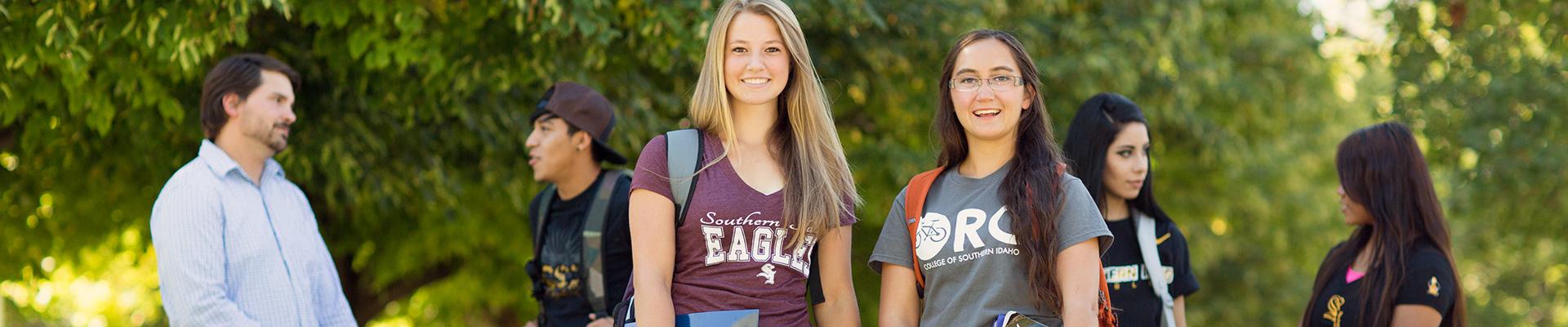 Two CSI students face the camera, smiling.